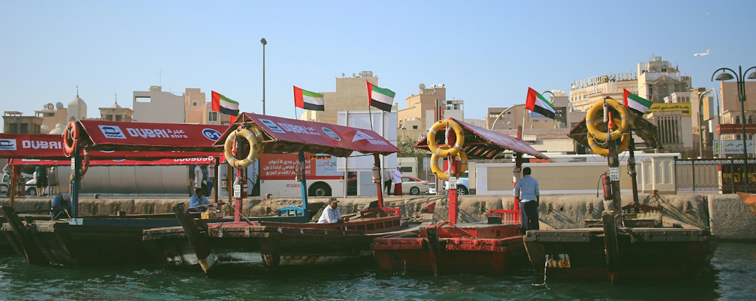 assorted-colour wooden boats on Dubai docks